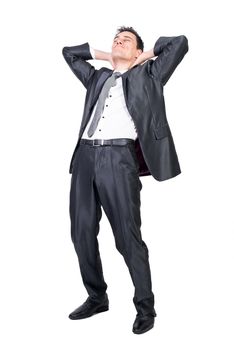 Full body of pleasant male in suit chilling with hands behind head and closed eyes in studio against white background