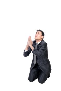 Full body of helpless male entrepreneur in formal suit keeping hands together while begging for forgiveness in studio against white background