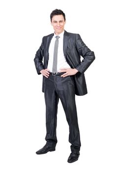 Full body of positive male in formal suit looking at camera with hands on waist isolated on white background in studio