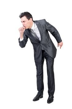 Full length of sick young male manager with dark hair in formal outfit coughing while standing against white background