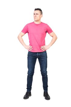 Full length dissatisfied male with hands on waist frowning and looking at camera with suspicion isolated on white background