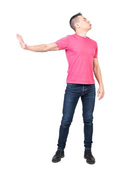 Full length of offended man with dark hair in casual clothes pouting lips with closed eyes and gesturing stop against white background