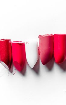 Beauty texture, cosmetic product and art of make-up concept - Cutted lipstick close-up isolated on white background