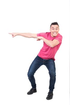 Full body of joyful male model pointing aside and looking at camera with toothy smile while standing isolated on white background