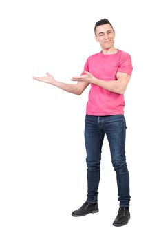 Full body of happy male in casual clothes pointing aside with hands and looking at camera while standing isolated on white background
