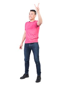 Full body of positive male model in casual outfit showing peace gesture and looking at camera isolated on white background