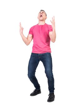Full body of suffering young male in pink t shirt and jeans screaming desperately with closed eyes against white background