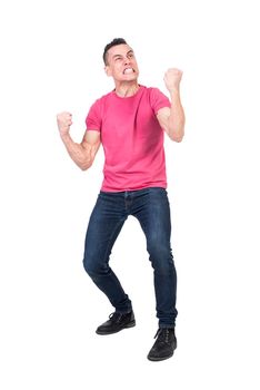 Full length of furious young male with dark hair in t shirt and jeans gritting teeth and clenching fists aggressively while standing against white background