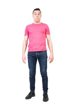 Full body of amazed male model in casual clothes looking at camera with confused face isolated on white background in studio