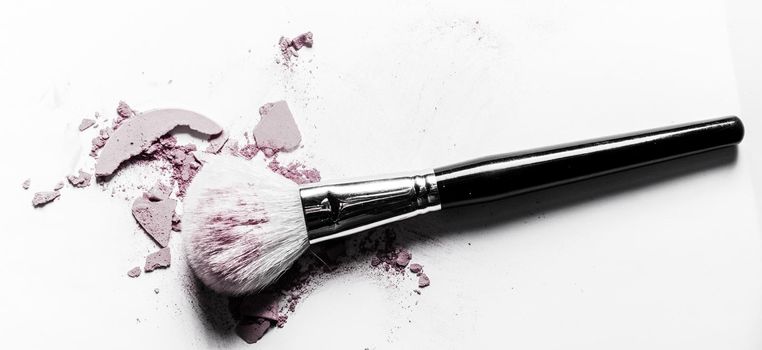 Beauty texture, cosmetic product and art of make-up concept - Brush with crushed eyeshadow and powder close-up isolated on white background