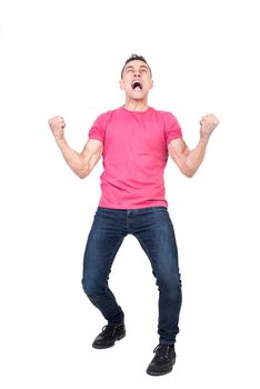 Full body of expressive young male in casual outfit clenching fists and screaming loudly while celebrating success isolated on white background