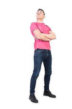 Full body of lofty man standing with folded arms and looking away with arrogant face expression on white background