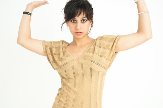 pretty girl staring at camera raising her arms with collected hair on white background, medium shot