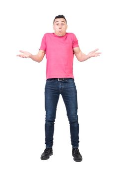 Full length of young uncertain man in t shirt and jeans shrugging shoulders and making confused face expression against white background