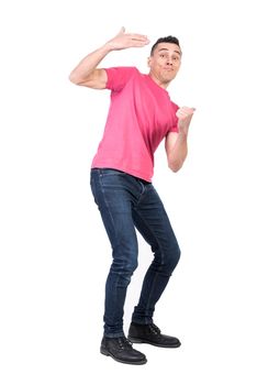 Full body of male model making inviting gesture for hangout in studio against white background and looking at camera with excited glance