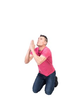 Full body of male with prayer hands kneeling and begging for help while looking up with hope on white background