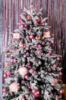 Christmas holiday, fir branches, conifer cones, silver, blue, white ornaments.Decorated Christmas tree.Glittering ball for new year