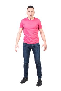 Full body of surprised male in casual wear looking at camera with opened mouth isolated on white background in light studio