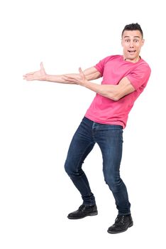 Full body of astonished male model pointing aside with hands and looking at camera with mouth opened isolated on white background