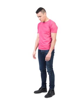 Full body of sad male model with short hair in casual outfit looking down isolated on white background in light studio