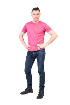 Full body of self confident male model smirking and looking at camera with hand son waist isolated on white background