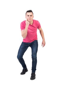 Full body of male guard pointing at eye and looking at camera with confident face expression isolated on white background in light studio