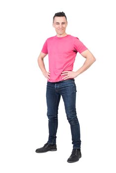 Full body of positive male model in casual outfit looking at camera with smile while standing with hands on waist isolated on white background