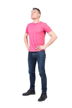 Full body of male guard looking at camera with serious face while standing with hands on waist isolated on white background