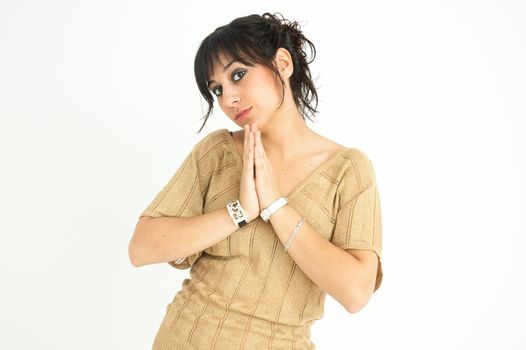 pretty girl with joined hands like a good and formal girl, with collected hair, on white background, medium shot