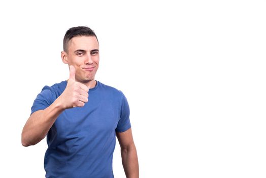 Studio portrait with white background of a man giving thumb up gesturing to be okay