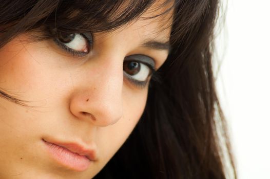 Pretty brunette girl looking straight ahead, on white background, close up