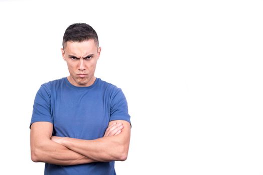 Studio portrait of an anger man with his arms crossed with a white background
