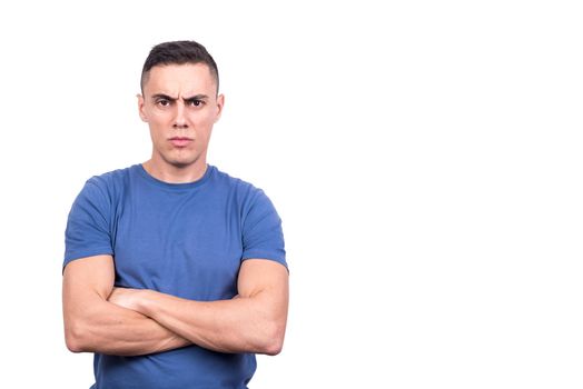 Studio portrait with white background of a man with arms crossed and angry expression