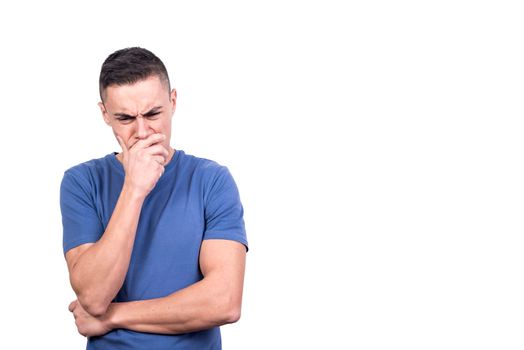 Studio shot of a man with his hand on his face thinking seriously in a white background