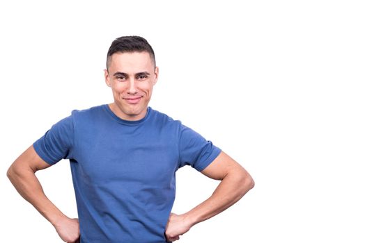 Studio portrait of a man with his hands on his hips and expression of satisfaction in a white background