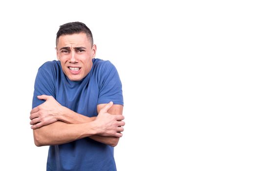 Studio photo with white background of a man gesturing that he is cold while facing the camera