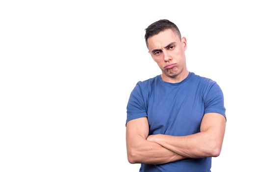 Studio portrait with white background of a man with folded arms and a bored look on his face