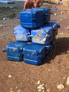 torn off parts of a plastic pontoon lying on the shore after a hurricane in Egypt. High quality photo