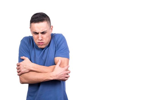 Studio photo with white background of a man gesturing that he is cold with the arms