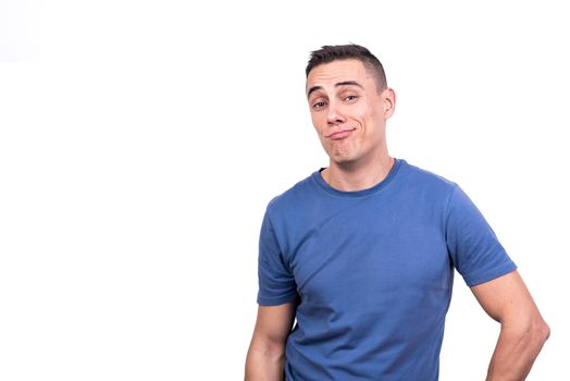 Studio portrait with white background of a man looking at camera with cocky expression