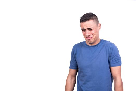 Studio portrait with white background of a man crying