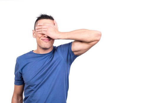 Studio photo with white background of a man covering his eyes with his hand to keep out of sight