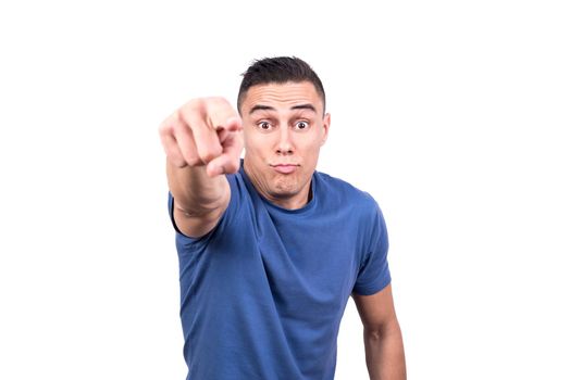 Studio portrait with white background and selective focus on the face of a man pointing ahead