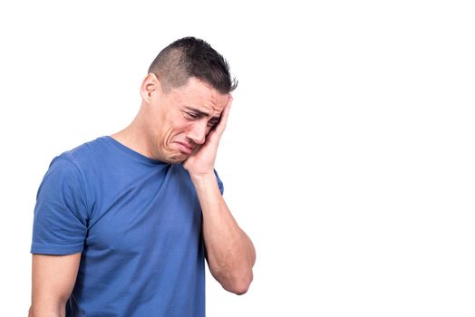 Studio photo with white background of an adult man crying with sad expression