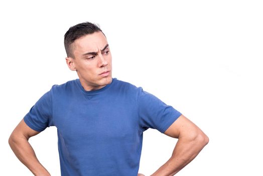 Studio photo with white background of a man with arms on hips turning around with a defiant look