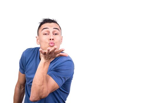Studio photo with white background of a man blowing a kiss while gesturing with the hand