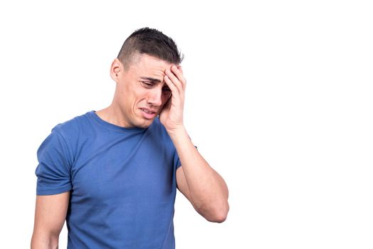 Studio photo with white background of a man with his hand on his head crying