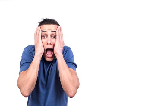 Studio photo with white background of a man with his hands over his face screaming in fear