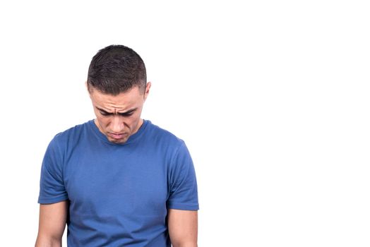 Studio portrait with white background of a sad adult man standing while looking down