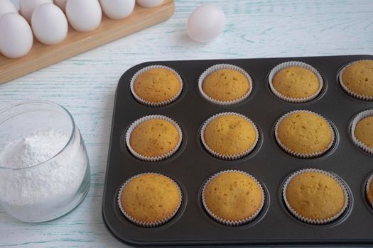 the vanilla muffins are cooled in a baking dish. Confectionery form. Fresh homemade baking concept. High quality photo. Freshly baked bran muffins cooling down in baking tin